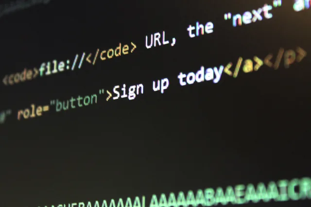 Detailed view of HTML and CSS code on a computer screen, concept of programming. Landing page software providers compared in alphabetical order: GetResponse, Systeme.io and Unbounce plans and prices