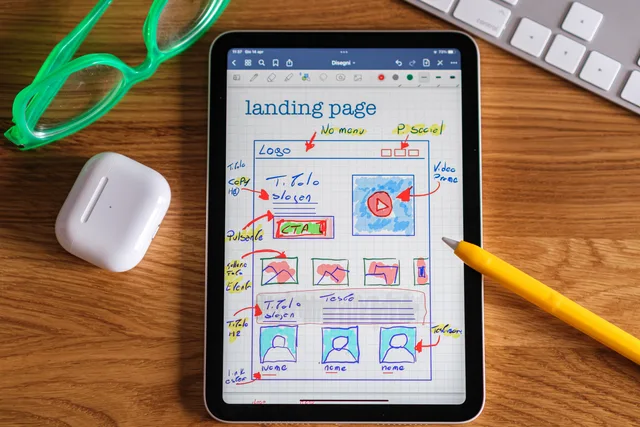 Close-up of tablet showing a hand-drawn landing page design, ideal for web development concepts. Leadpages, Instapage and Landingi as a landing page software shortlist, with plan limits compared