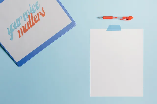 A blank sheet with a pen and motivational message on a blue backdrop. Landing page software launch validation