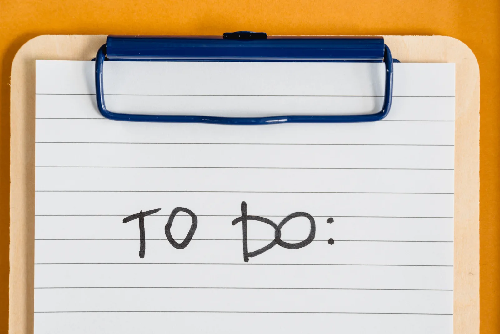Clean and simple image of a to-do list on a clipboard with lined paper.