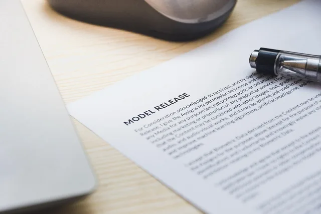 paper, model release, form, document, signing, pen, desk, agreement, business, contract, signature. Who owns what on a landing page, from the offer to the domain